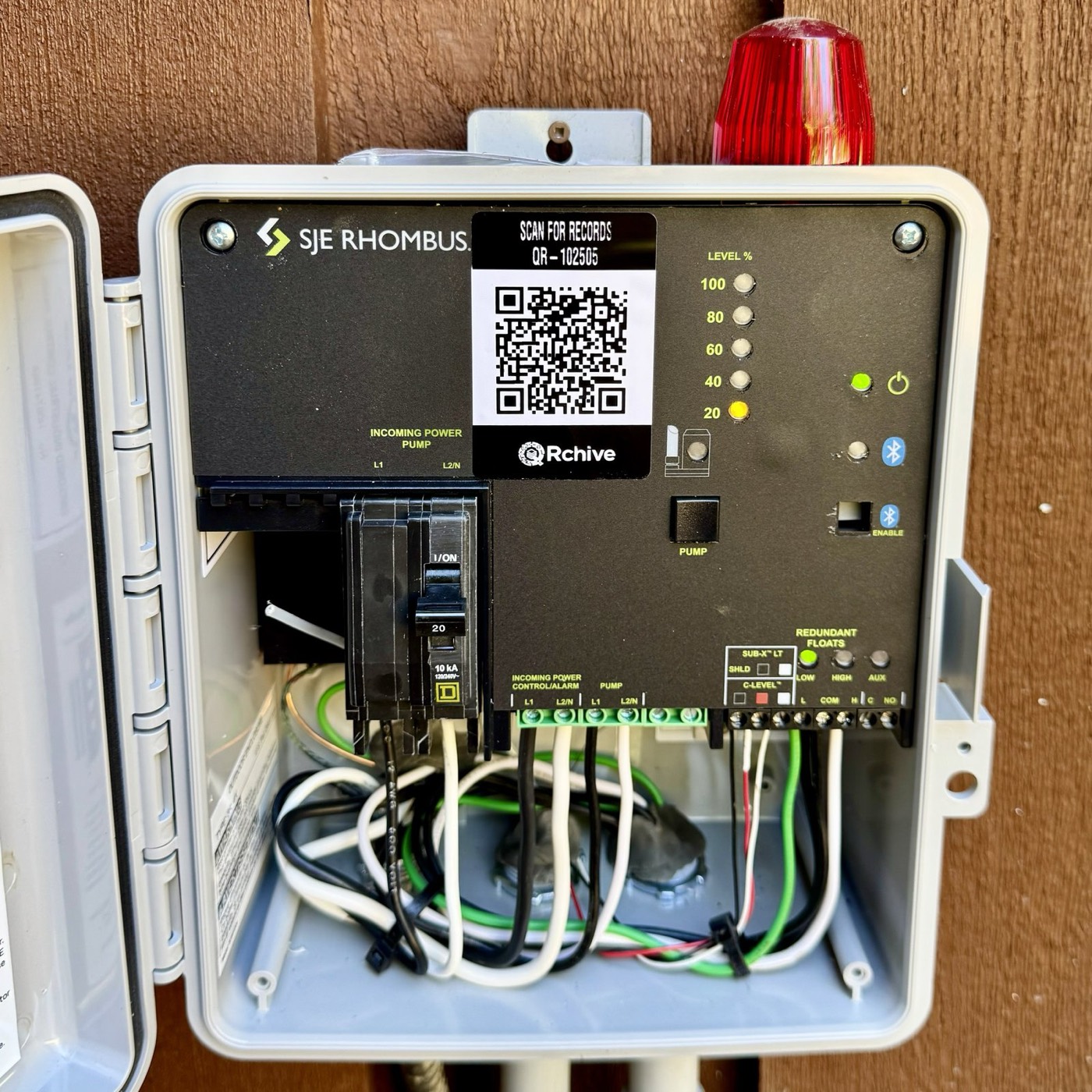 QRchive sticker on an SJE Rhombus pump-control panel